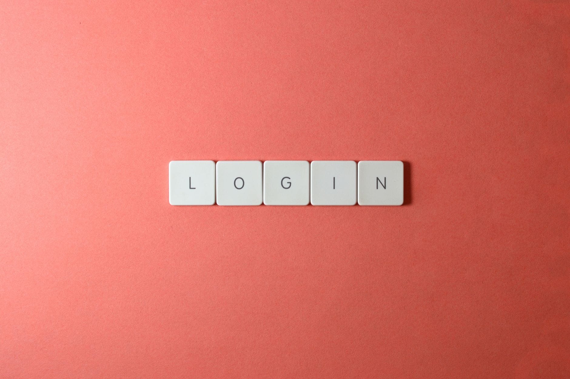 Zbliżenie klawiszy klawiatury z napisem login na koralowym tle Zbliżenie klawiszy klawiatury z napisem login na koralowym tle